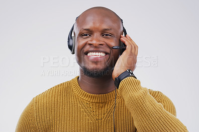 Buy stock photo African man, smile and studio with headphones for customer service or call center, smile for communication. Male person, white background and microphone with happiness for chat or telemarketing