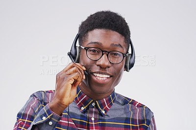 Buy stock photo Studio portrait of a handsome young male customer service representative wearing a headset against a grey background