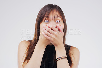 Buy stock photo Studio shot of a young woman looking shocked against a grey background