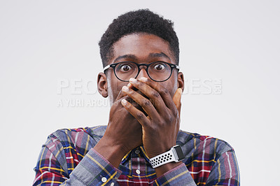 Buy stock photo Studio shot of a young man looking shocked against a grey background