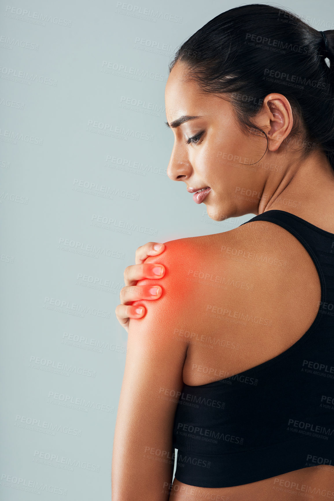 Buy stock photo Woman, fitness and shoulder injury with pain for sport, accident or inflammation on a gray studio background. Young, female person or model with sore bruise, red glow or muscle tension for strain