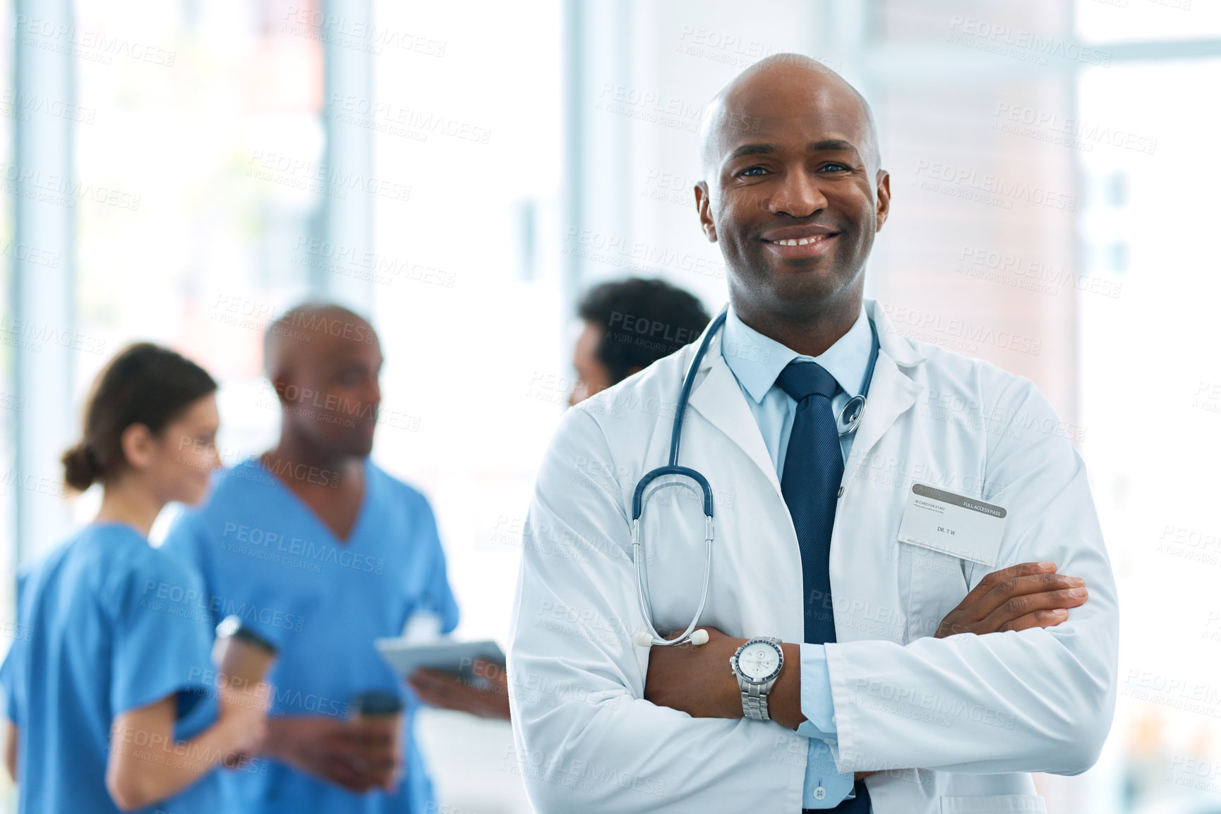 Buy stock photo Man, leader and portrait of doctor in hospital, healthcare or clinic with medical expert nurses to trust in quality care. Black person, medicine and happy neurosurgeon, arms crossed or confidence