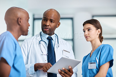 Buy stock photo Low angle shot of a group of medical practitioners having a discussion in a hospital