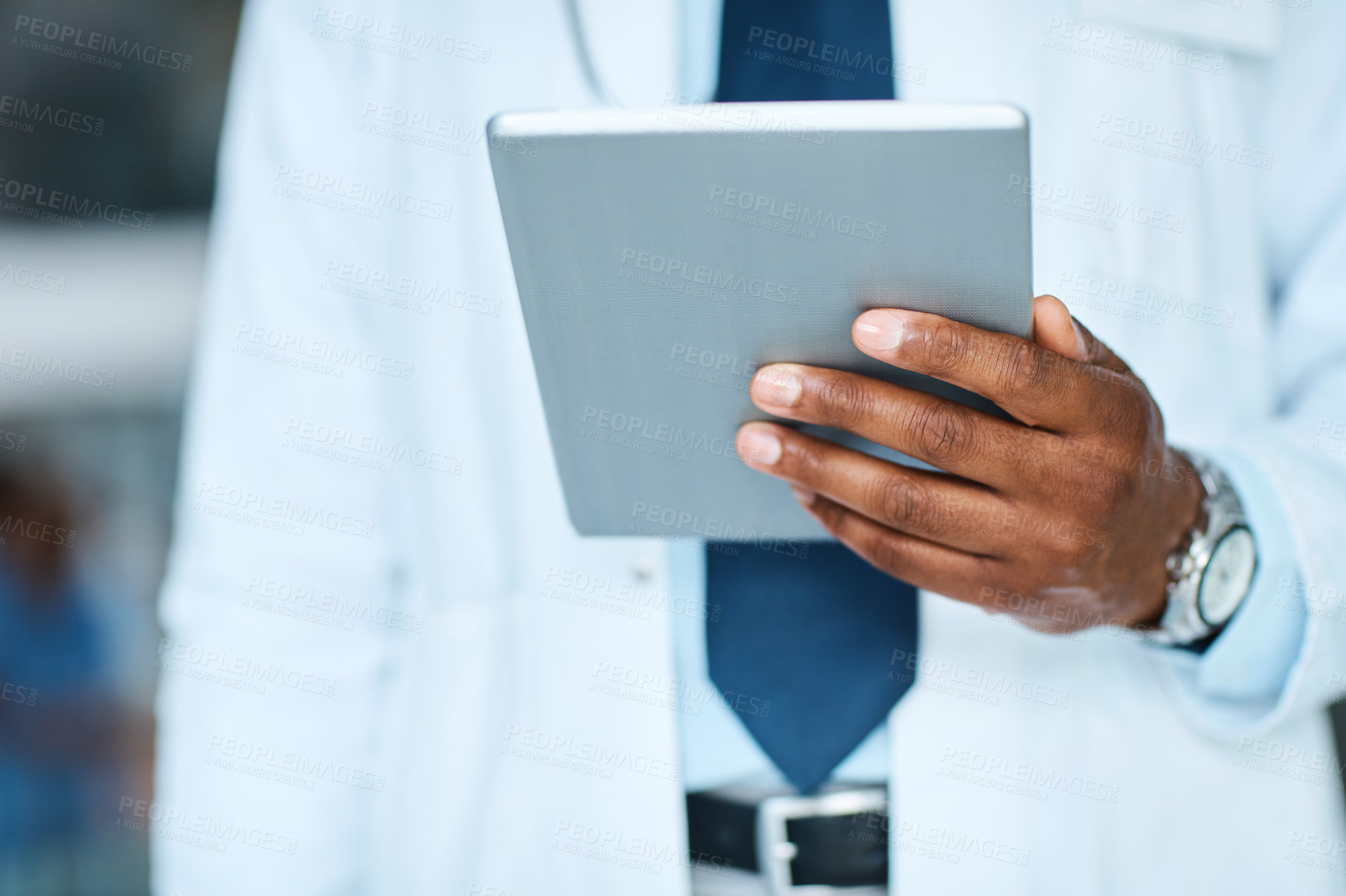 Buy stock photo Closeup shot of an unrecognizable doctor using a digital tablet