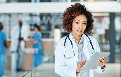 Buy stock photo Portrait of a young doctor using a digital tablet in a hospital