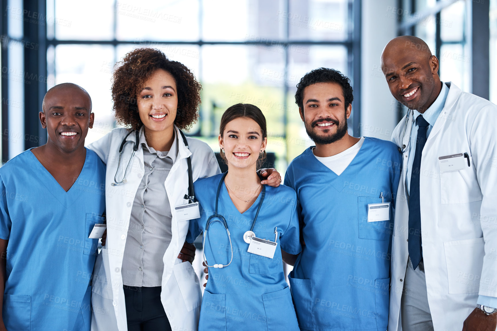 Buy stock photo Portrait, embrace and doctors with smile, hospital and collaboration with interns, group and healthcare. Team, men and women in uniform, medical professional and together to help, happy and clinic