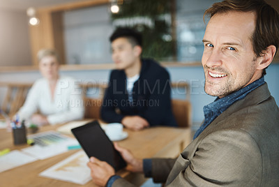 Buy stock photo Portrait of a mature businessman using a digital tablet while in a meeting in an office