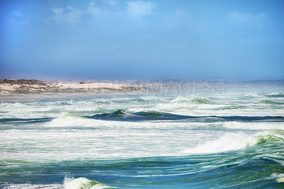 Buy stock photo Scenic coastal landscape of rough ocean tides with big waves at a windy beach. Copy space at the sea with a cloudy and misty sky background above the horizon on the coast of Western Cape South Africa