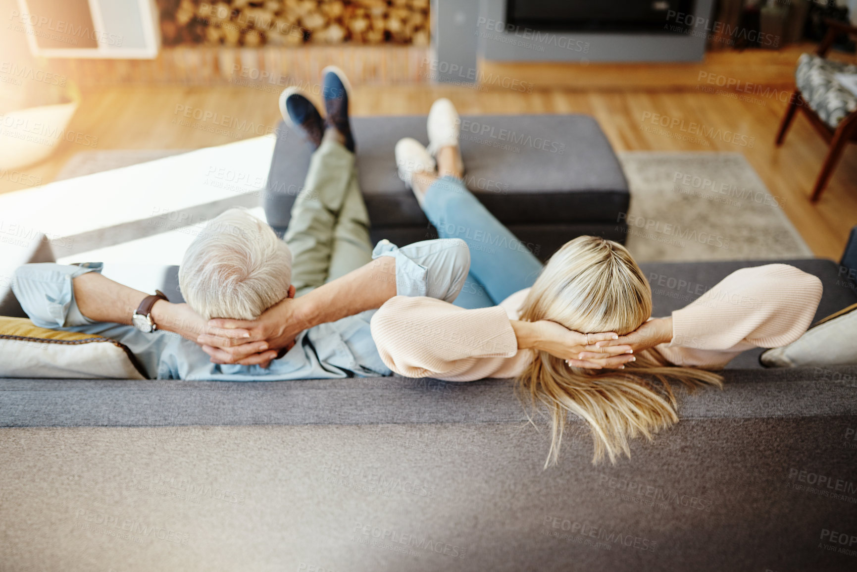 Buy stock photo High angle shot of an unrecognizable mature couple relaxing on the sofa at home