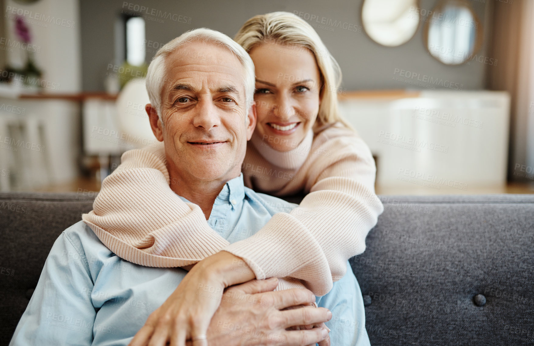 Buy stock photo Hug, portrait and mature couple with love, healthy relationship and loyalty to partner in home on sofa. Face, senior man and happy woman embrace together for connection, support and commitment in USA