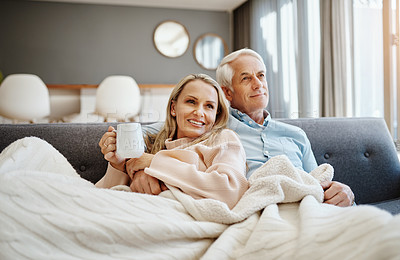 Buy stock photo Shot of a happy mature couple relaxing on the sofa at home