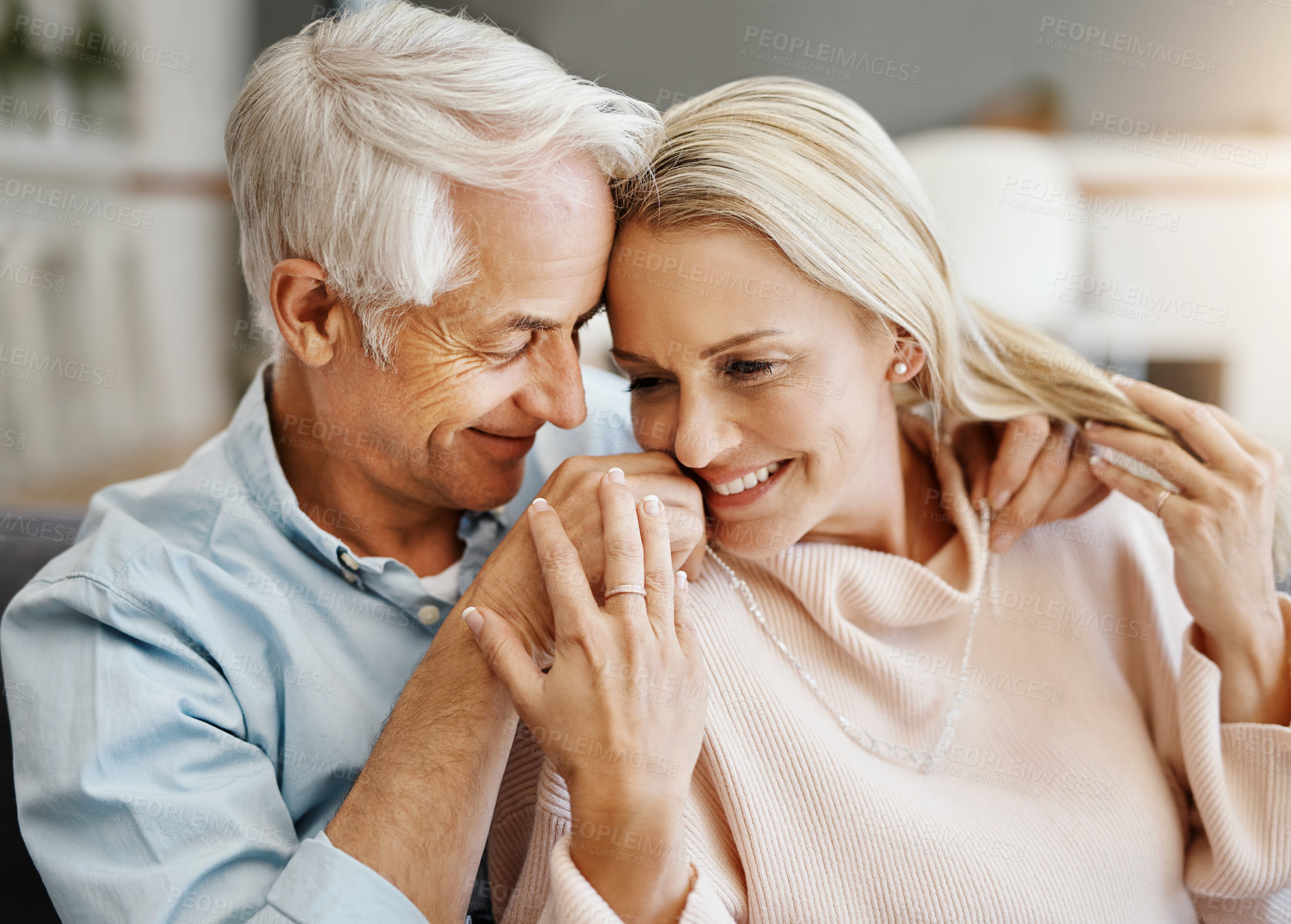 Buy stock photo Shot of a happy mature couple relaxing on the sofa at home