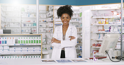 Buy stock photo Portrait of an attractive young pharmacist standing behind the counter with arms folded in a chemist