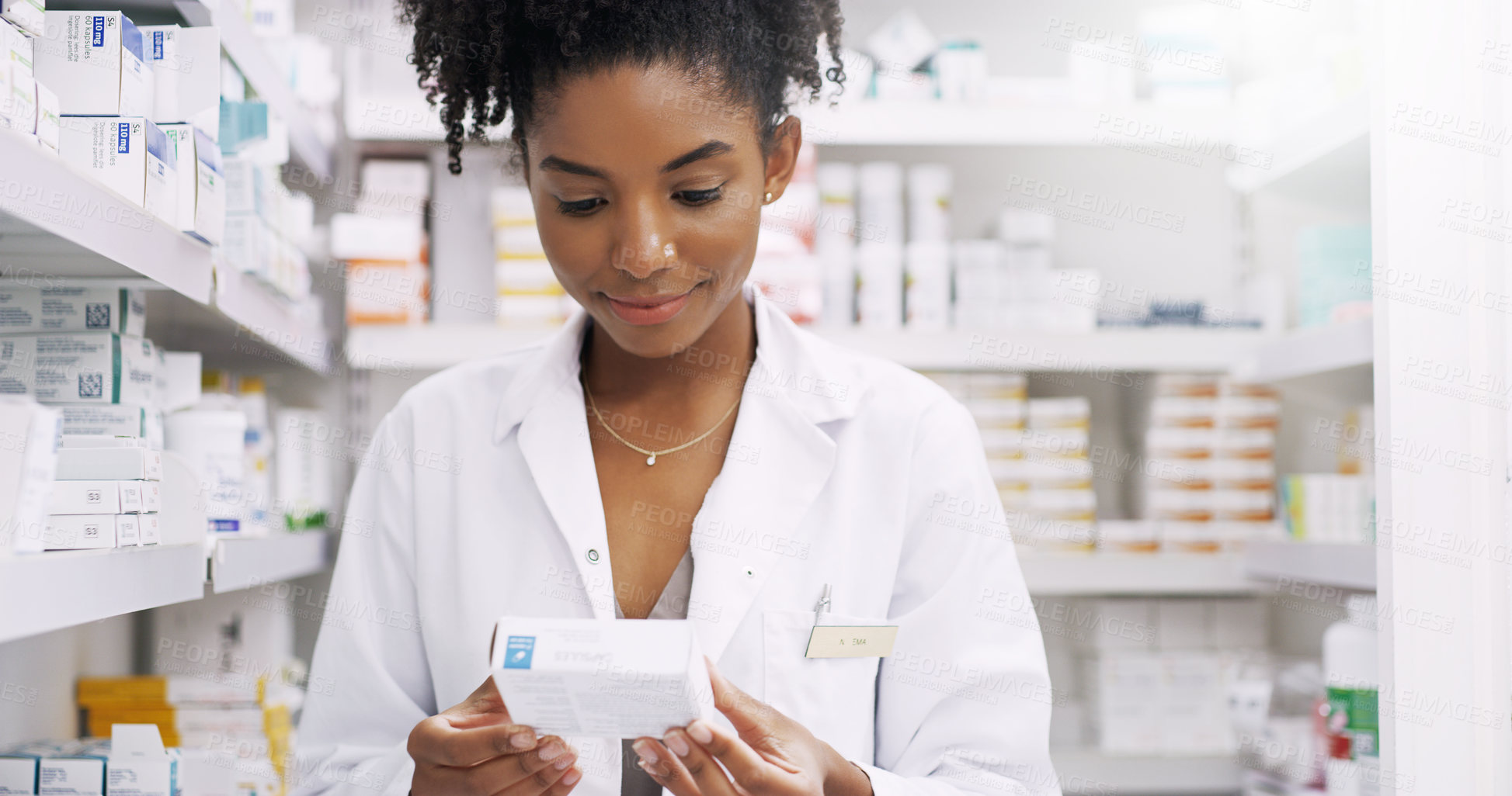 Buy stock photo Woman, pharmacist and checking box with medication, side effects or symptoms at pharmacy. Young African, female person or medical employee reading expiry date on pharmaceutical product at store