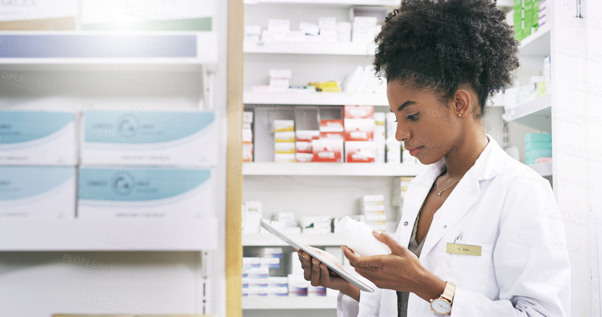 Buy stock photo Cropped shot of an attractive young pharmacist using a digital tablet to fill a prescription in a chemist