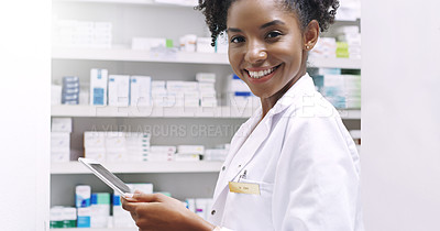 Buy stock photo Cropped portrait of an attractive young pharmacist holding a digital tablet in a chemist