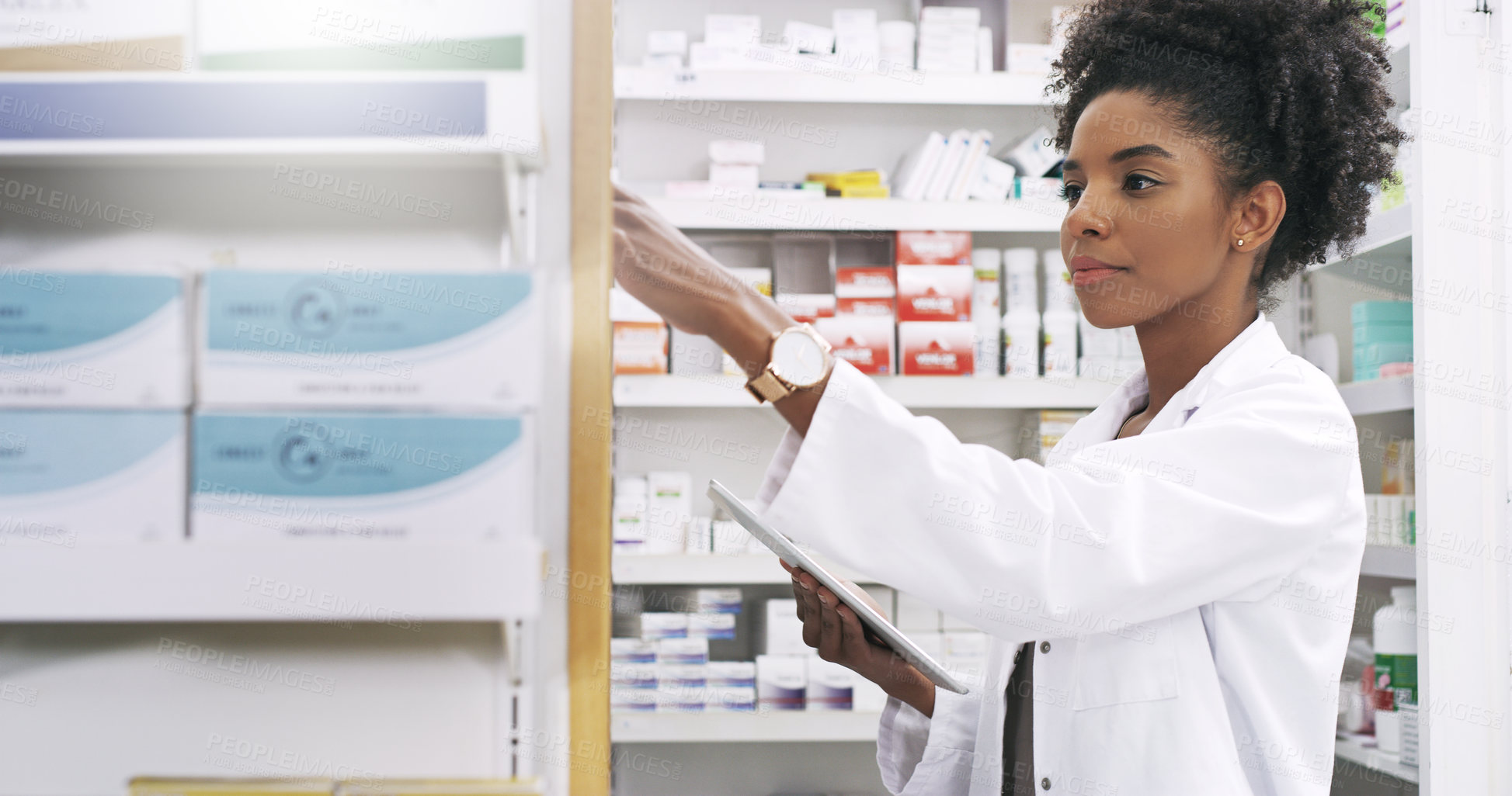 Buy stock photo Cropped shot of an attractive young pharmacist taking out a product from the shelves while holding a digital tablet