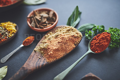 Buy stock photo Table, spoons and group of spices for cooking, curry and ingredients for flavor on background. Row, selection and collection of herbs or organic turmeric, textures and culinary condiments for food