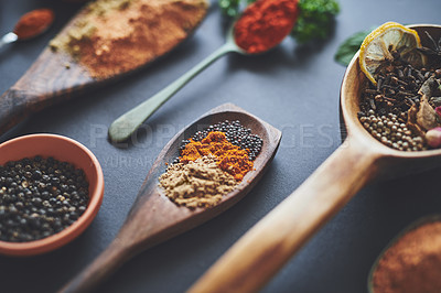 Buy stock photo Table, spoons and group of spices for cuisine, curry and ingredients for flavor on background. Row, selection and collection of herbs or organic turmeric, textures and culinary condiments for food