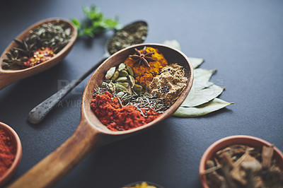 Buy stock photo Table, spoons and group of spices for nutrition, curry and ingredients for flavor on background. Row, paprika and collection of herbs or organic turmeric, textures and culinary condiments for food