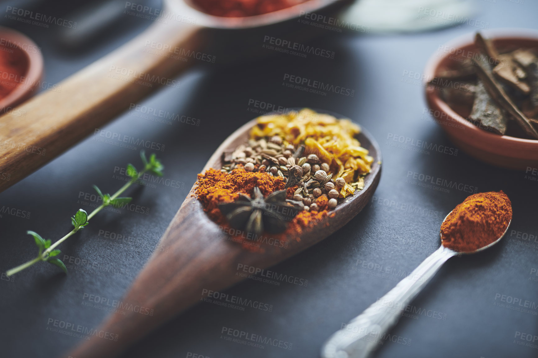 Buy stock photo Table, spoons and group of spices for diet, curry and ingredients for flavor on background. Choice, powder and collection of herbs or organic turmeric, textures and culinary condiments for food