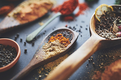 Buy stock photo Table, spoons and collection of spices in abstract, powder and ingredients for flavor on background. Selection, curry and cooking with herbs or organic seasoning, textures and culinary condiments