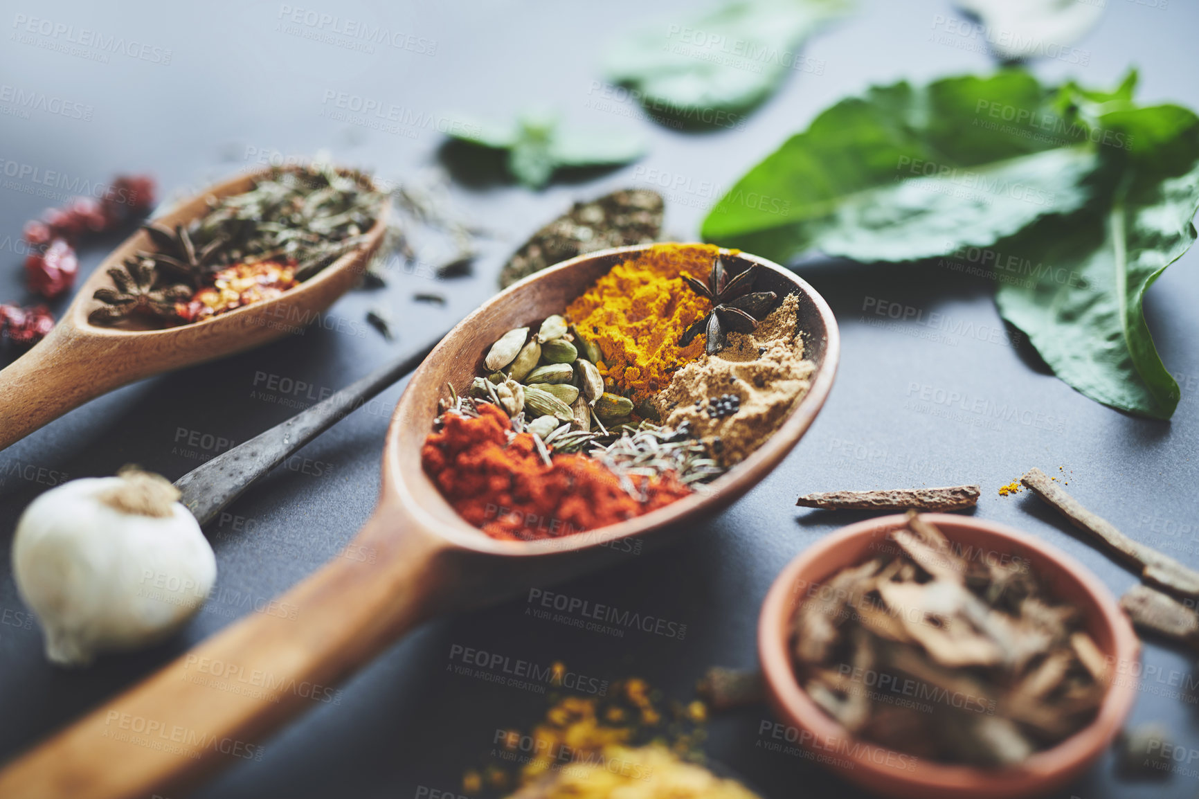 Buy stock photo Kitchen, spices and leaves with herbs on counter with ingredients, flavor and seasoning for cooking. Seeds, curry and above utensils on table for meal prep, choice and variety for food at restaurant