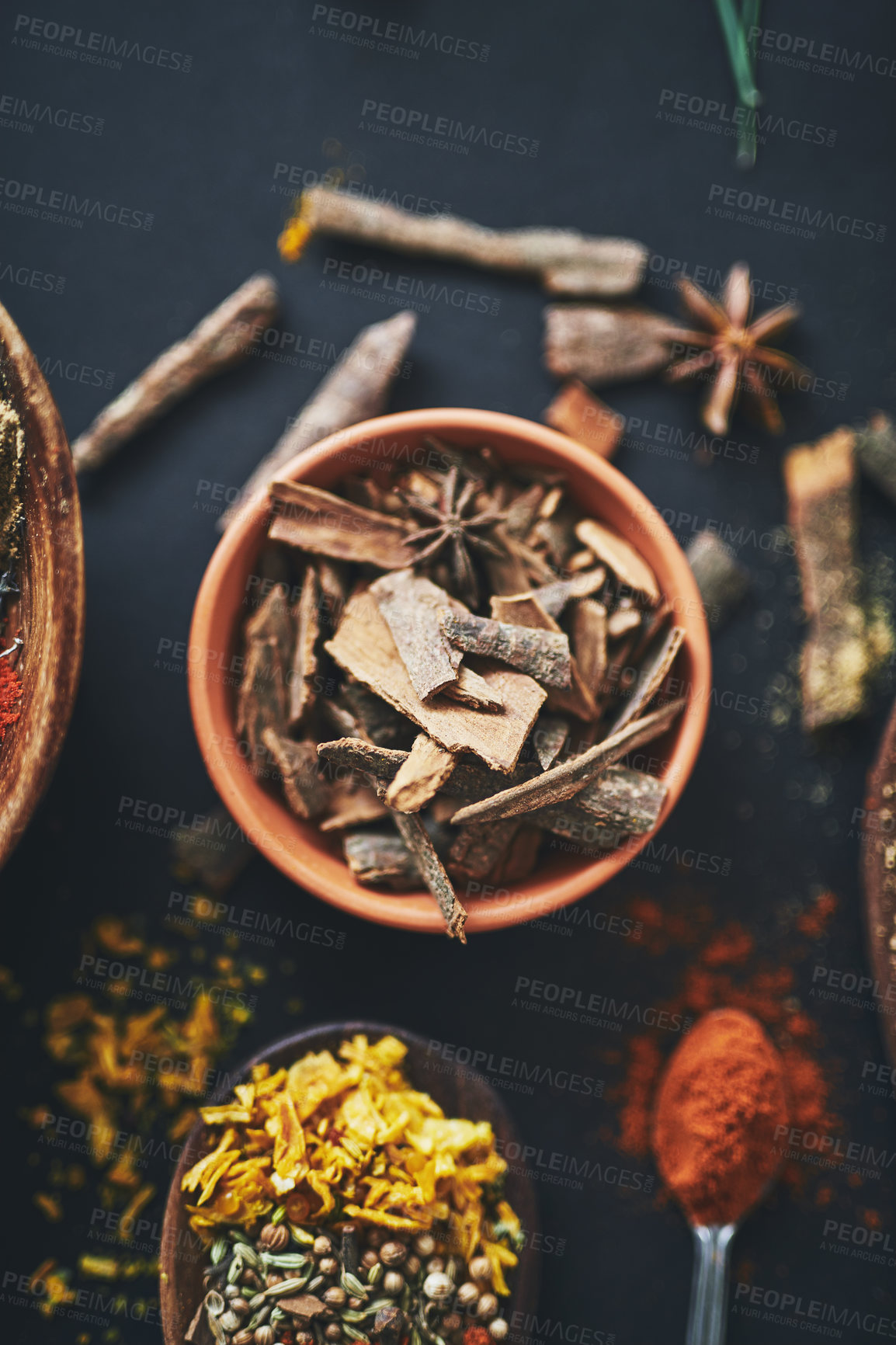 Buy stock photo Herbs, kitchen and spices in bowl on background for healthy, natural and organic Indian food. Table, top view and cloves above with paprika for seasoning, medicine and cooking powder with assortment