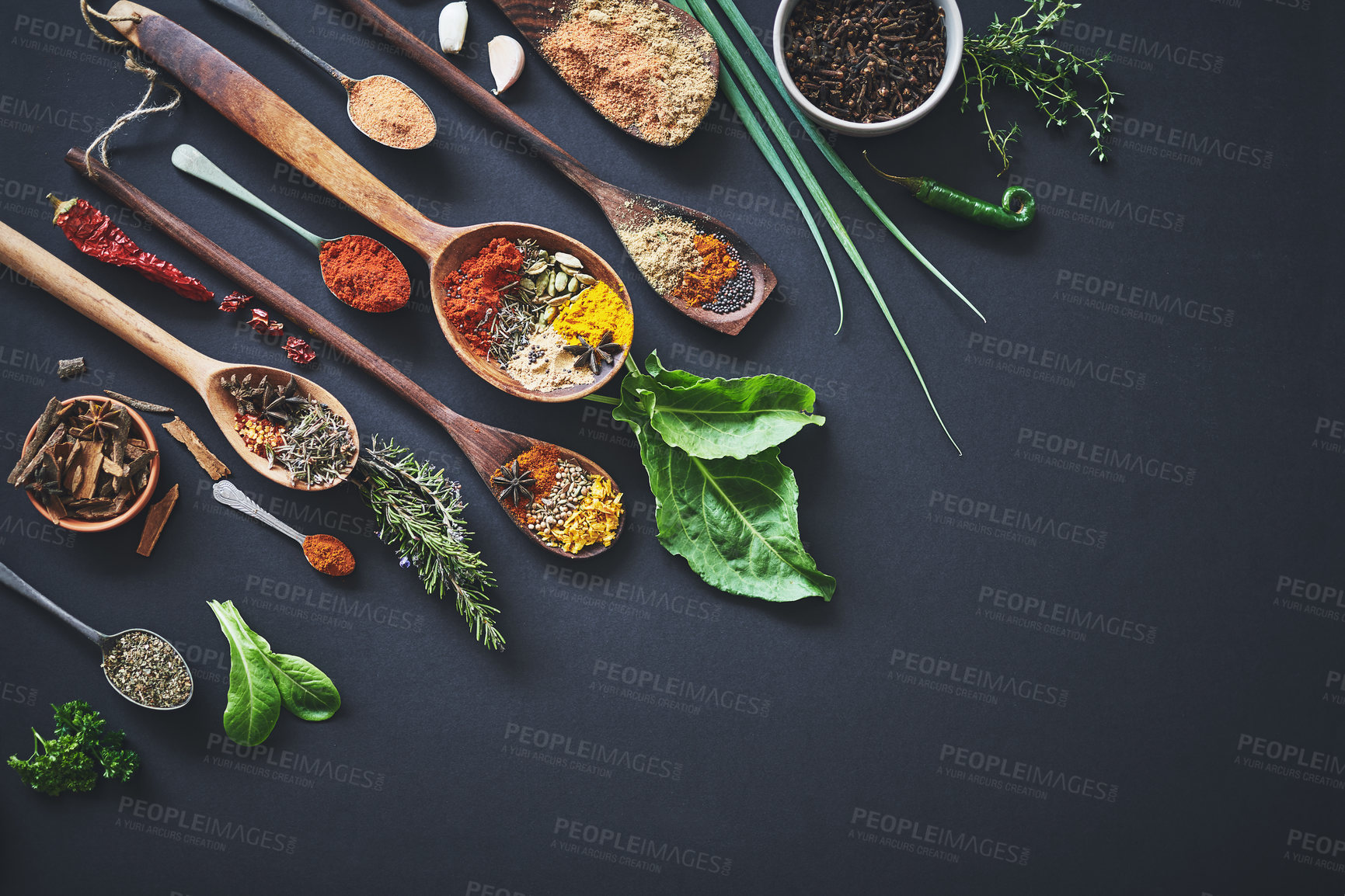 Buy stock photo Kitchen, herbs and spices with spoon on table with ingredients, flavor and seasoning for cooking. Seeds, leaves and above utensils on counter for meal prep, choice and variety for food at restaurant