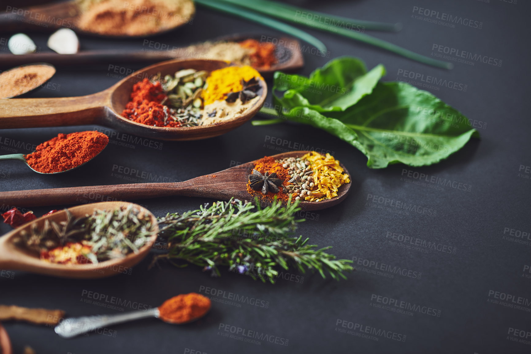 Buy stock photo Kitchen, curry and spices with spoon, cooking or ingredients for flavor with culinary art. Seeds, leaves and above utensils on counter for meal prep, cinnamon and rosemary for food at restaurant