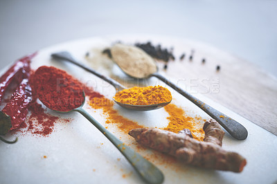 Buy stock photo Board, spices and variety on table with spoon, seasoning and ingredients for meal with powder. Top, collection and condiment with flavor for cooking, turmeric and paprika in Indian culture for aroma