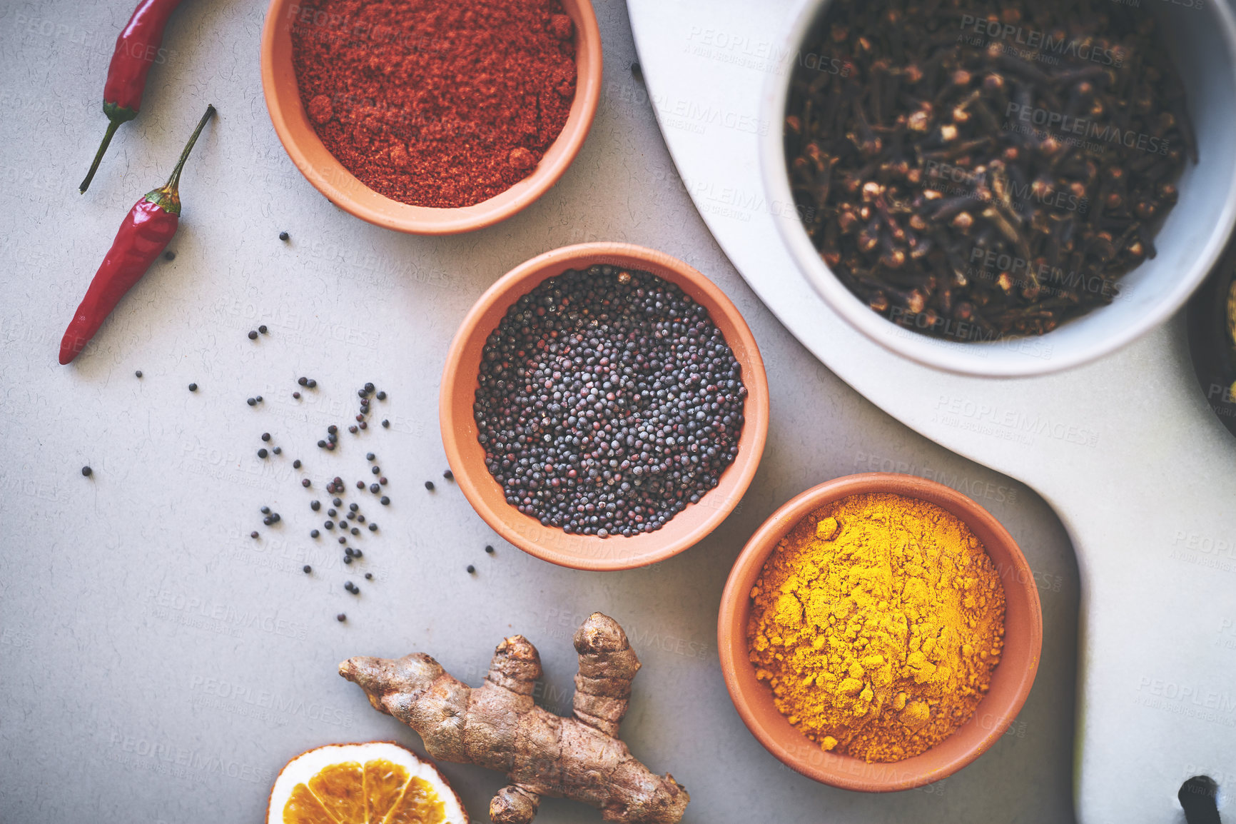 Buy stock photo Bowl, turmeric and board in gray background for spices, curry and sensory above for creativity with culinary. Studio, condiment and seasoning for cooking with powder, aroma or ingredients collection