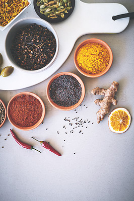 Buy stock photo Bowl, powder and board in white background for spices, curry and sensory appeal for creativity with culinary. Studio, condiment and seasoning for cooking with ginger, aroma and ingredients collection