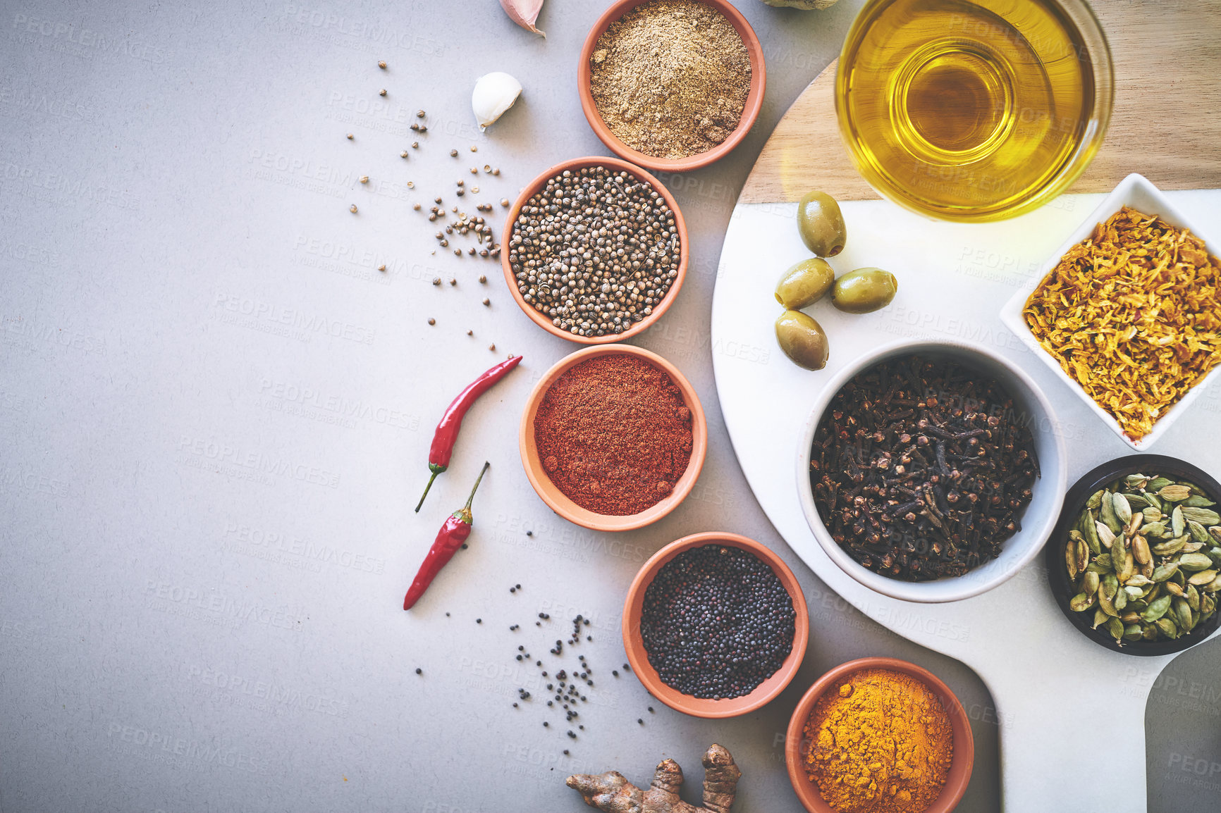 Buy stock photo Bowl, chilli and board in gray background for spices, powder and sensory appeal for creativity with culinary. Studio, condiment and ingredients for cooking with clove, aroma and seasoning by space