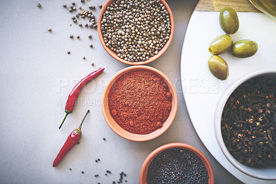 Buy stock photo Bowl, coriander and board in gray background for spices, powder and sensory appeal for creativity with culinary. Studio, condiment and ingredients for cooking with clove, aroma and seasoning by space