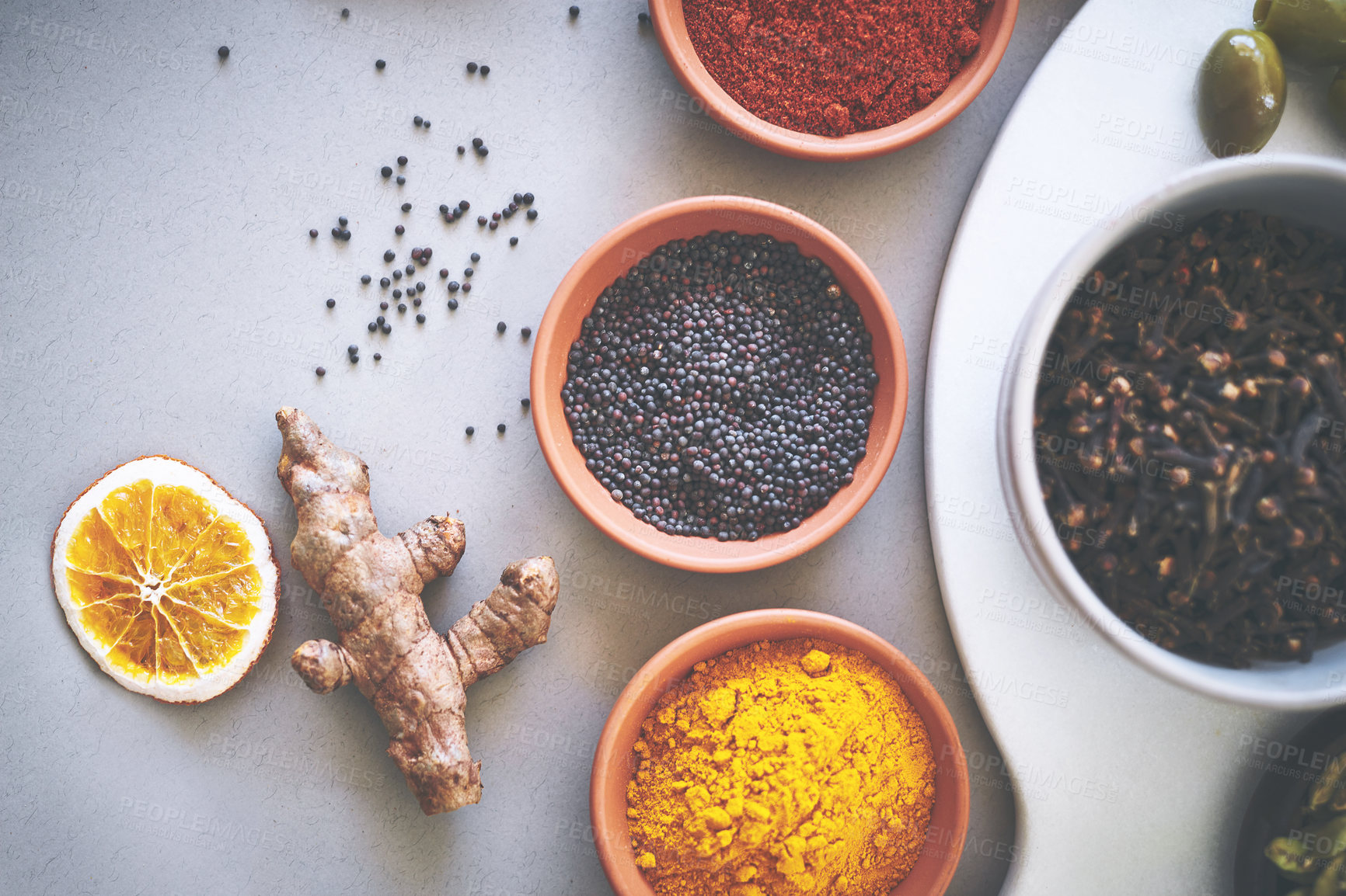 Buy stock photo Bowl, aroma and board in gray background for spices, powder and sensory appeal for creativity with culinary. Studio, condiment and flavor for cooking with ingredients, pepper and seasoning collection