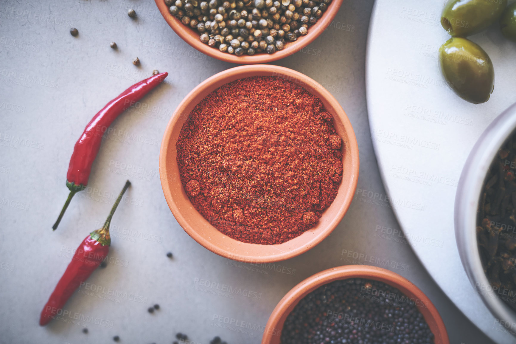 Buy stock photo Above, bowl and curry in gray background for spices, powder and variety for sensory appeal with culinary. Studio, condiment or flavor for cooking with ingredients, texture or seasoning collection