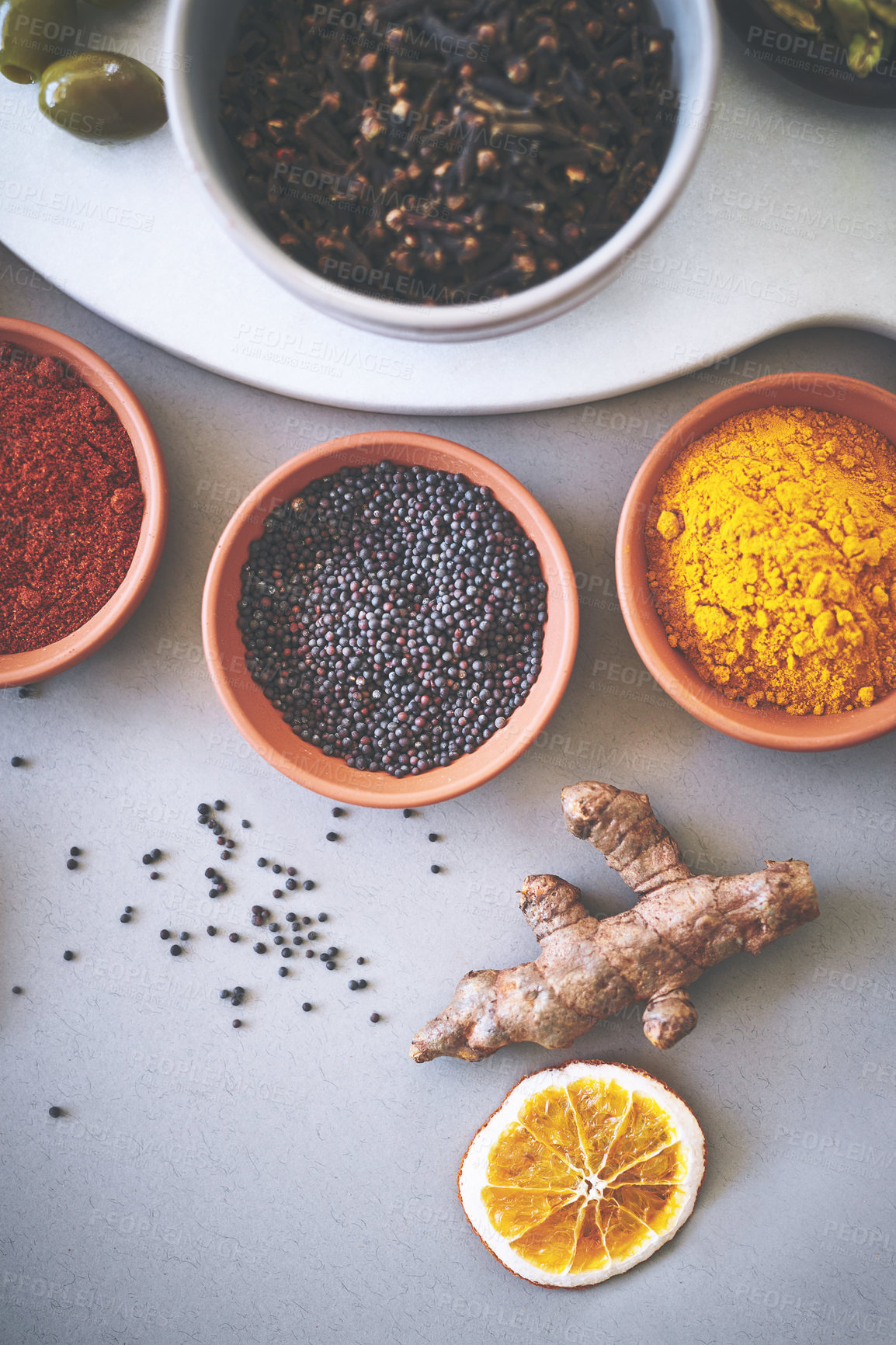 Buy stock photo Bowl, ginger and board in gray background for spices, powder and sensory appeal for creativity with culinary. Studio, condiment and flavor for cooking with ingredients, aroma and seasoning collection