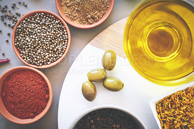 Buy stock photo Top view, bowl and spices in gray background for ingredients, powder and board for sensory appeal with culinary. Studio, condiment and flavor for cooking with seasoning, texture and herbs collection