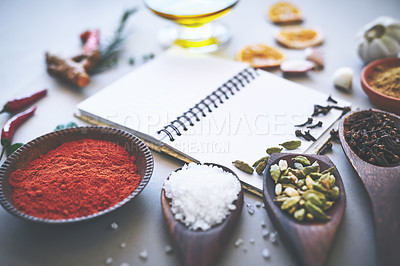 Buy stock photo Herbs, spices and seasoning on table with notebook, inspiration and flavor for cooking technique for culinary. Cookbook, instructions and food recipe with condiment of garlic, salt and ingredients