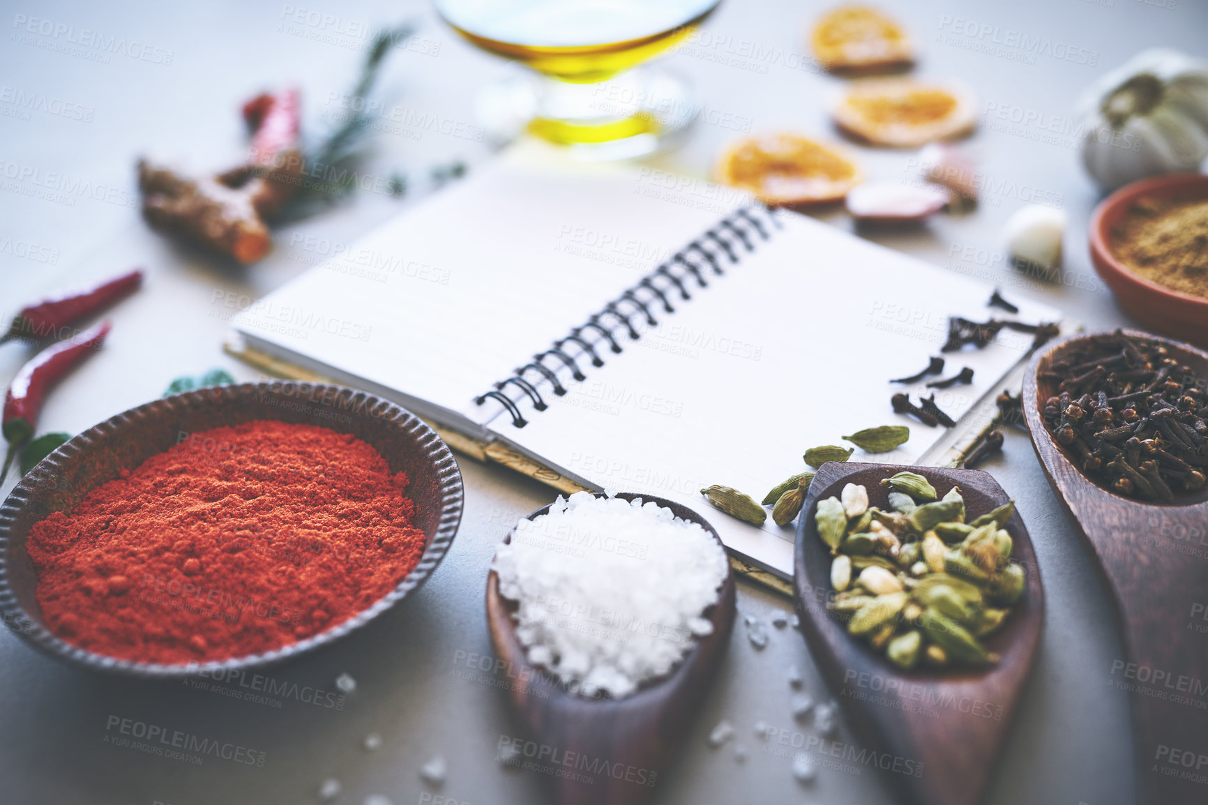 Buy stock photo Herbs, spices and seasoning on table with notebook, inspiration and flavor for cooking technique for culinary. Cookbook, instructions and food recipe with condiment of garlic, salt and ingredients