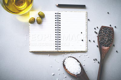 Buy stock photo Recipe, spices and flavor by white background with notebook, inspiration and ideas for cooking technique for culinary. Cookbook, instructions and ingredient with condiment of olives, spoon and studio