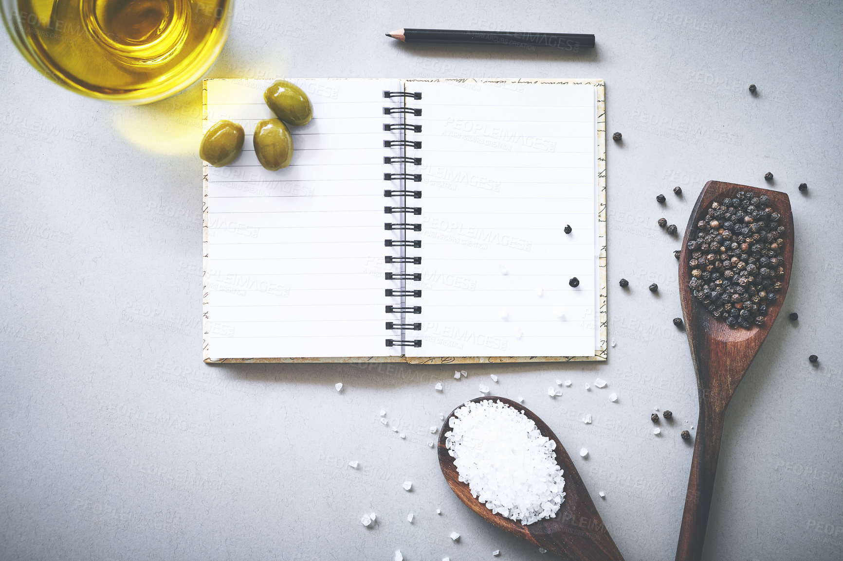 Buy stock photo Recipe, spices and flavor by white background with notebook, inspiration and ideas for cooking technique for culinary. Cookbook, instructions and ingredient with condiment of olives, spoon and studio