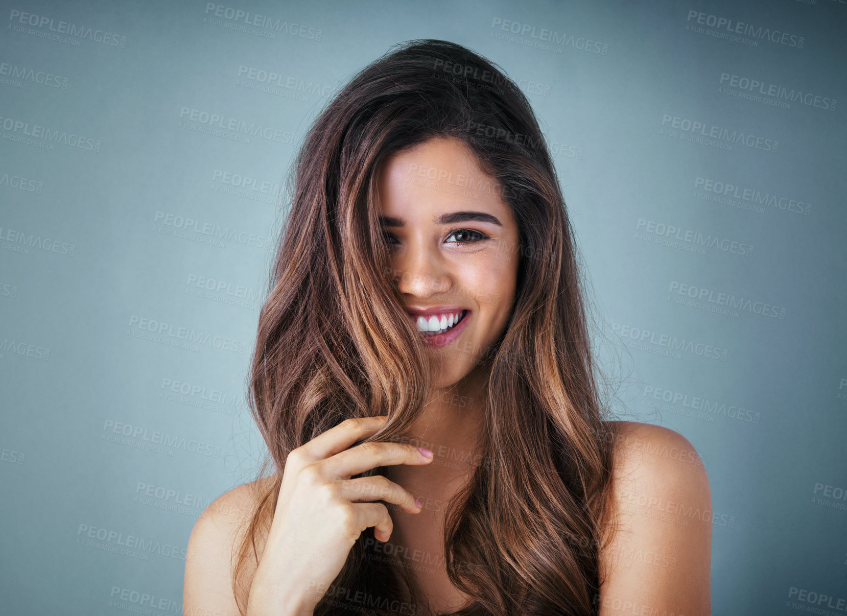 Buy stock photo Hair care, portrait and woman in studio with volume, collagen and salon treatment for beauty. Smile, confident and female person with brunette, long and shiny hairstyle isolated by gray background.