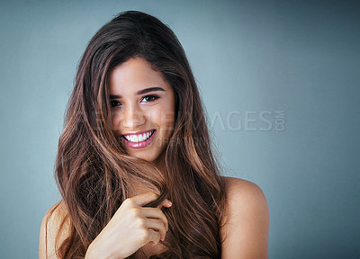 Buy stock photo Hair care, portrait and woman in studio with shiny, collagen and volume treatment for beauty. Smile, confident and female person with brunette, long and salon hairstyle by gray background with mockup