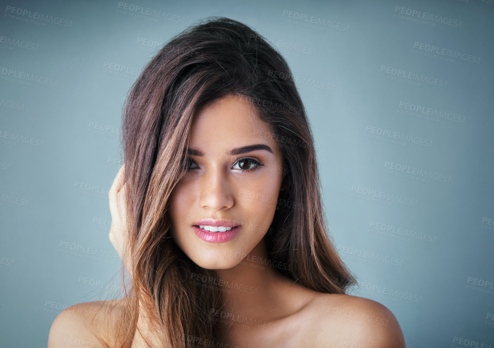 Buy stock photo Attractive woman, portrait and beauty with makeup for haircare, cosmetics or skincare on a gray studio background. Young face, female person or model with smile for facial, cosmetology or dermatology