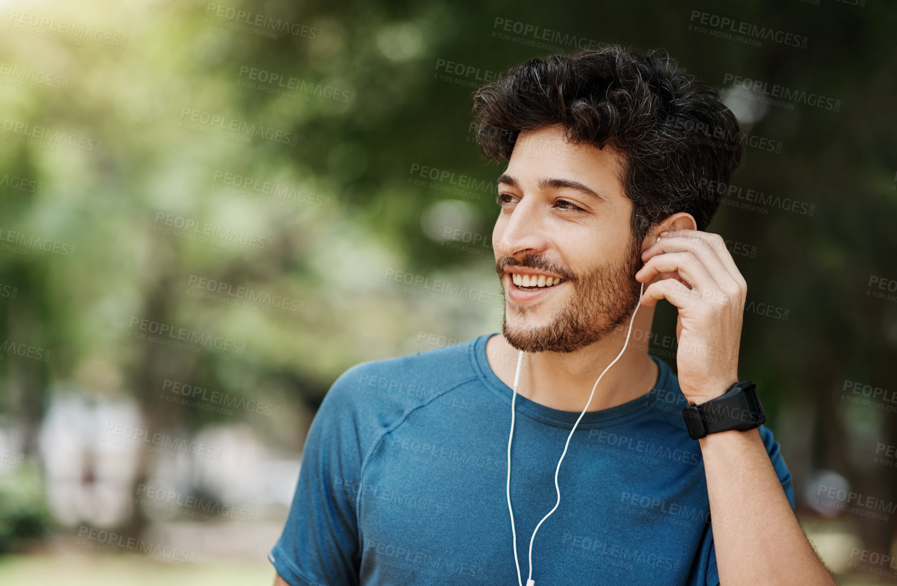 Buy stock photo Exercise, man and smile or thinking with earphones in park for workout and fitness with music in London. Runner, break and happy with routine for wellbeing or wellness and training with confidence