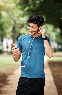 Buy stock photo Earphones, fitness and man with cellphone, outdoor and happiness with motivational podcast. Smile, healthy person or athlete with smartphone, radio or online for audio, exercise or workout with music