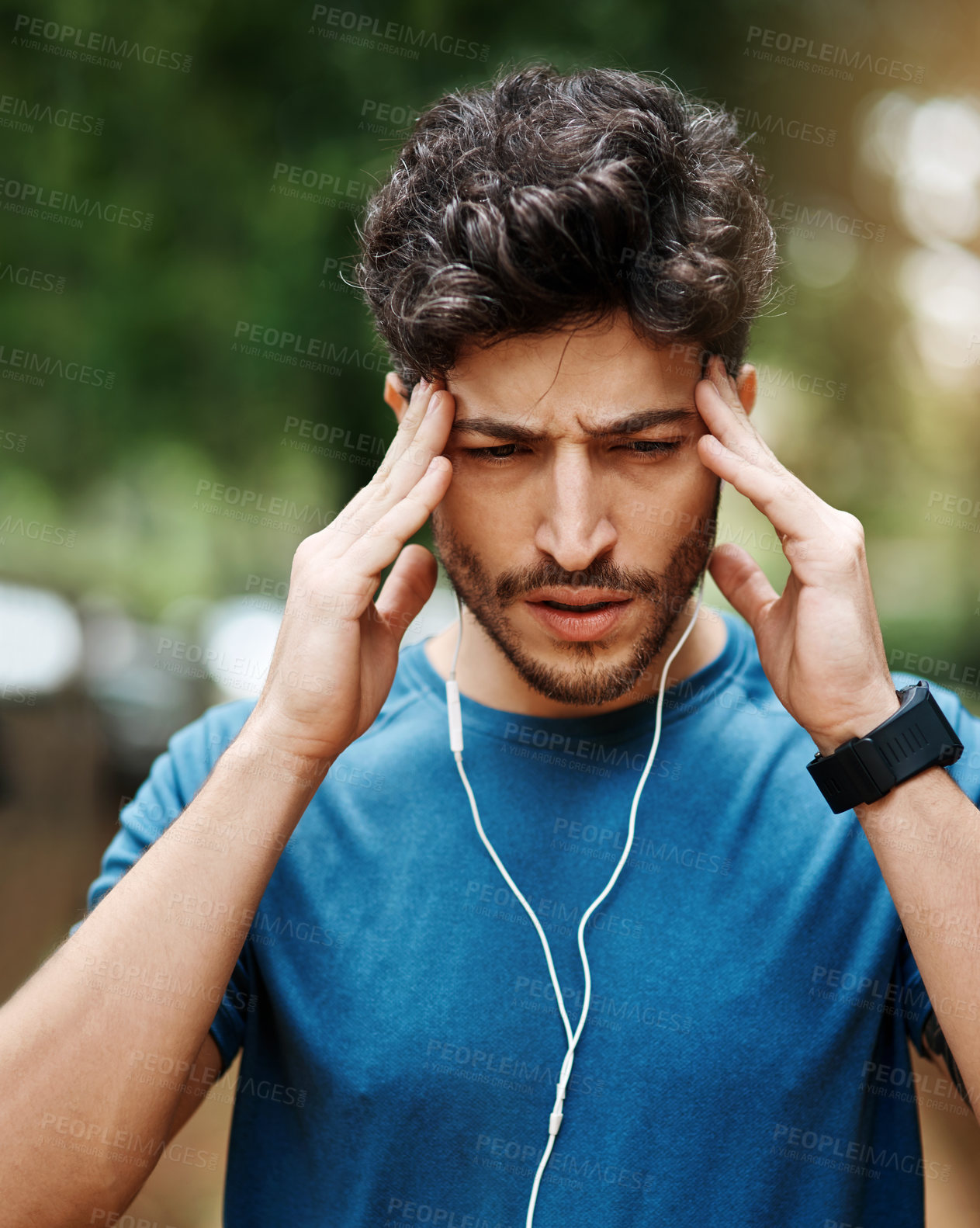 Buy stock photo Fitness, man and headache in outdoor with earphones for music for break, exercise and workout. Park, routine and stress or migraine with pain from training for wellness, tension and pressure