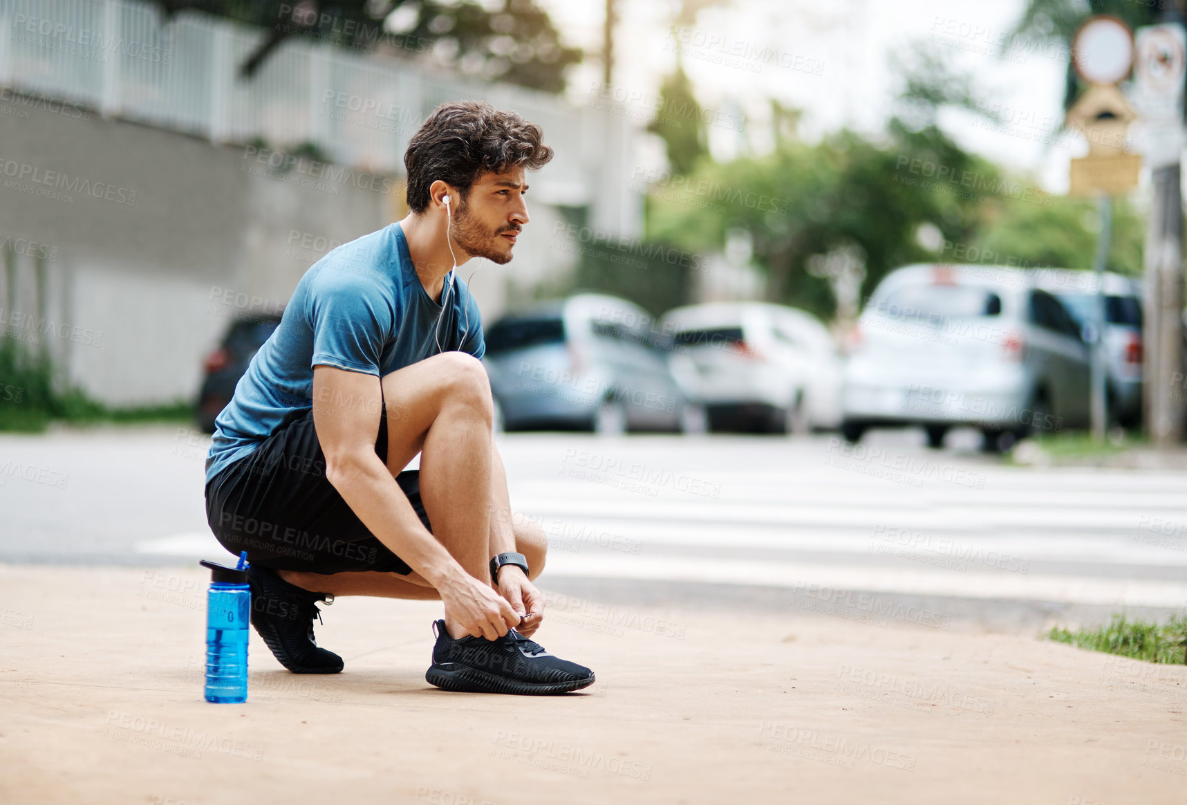 Buy stock photo Fitness, man and tying shoelace in street, exercise and workout or safety preparation with morning routine. Earphones, audio tech and streaming motivation or music, runner and athlete outside